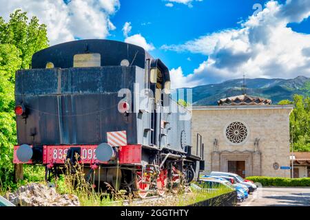 Steam locomotive 835.092 of the 'Ferrovie dello Stato' in front of the Church of the 'Madonna Pellegrina, Sulmona, Italy Stock Photo