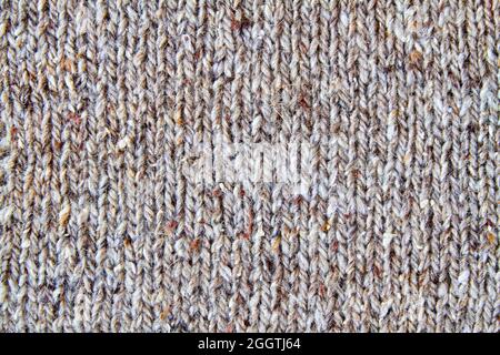 Brown or gray knitted textured background. Closeup Stock Photo