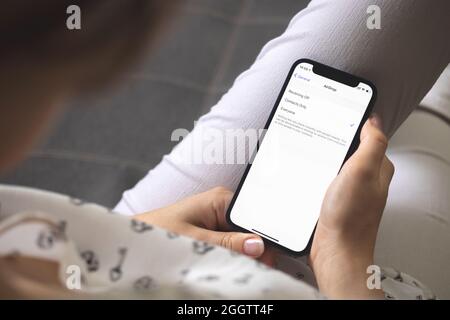 Kharkov, Ukraine - August 25, 2021: Woman open AirDrop setting screen closeup Stock Photo
