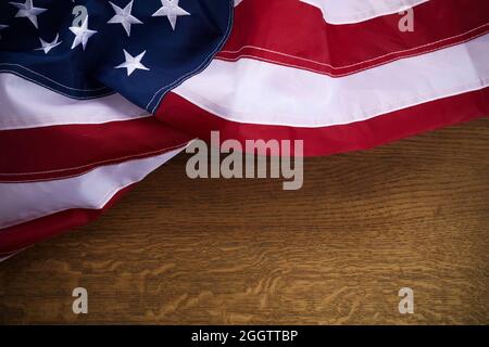 American flag on old wooden board. Celebration frame with free space for text. Stock Photo