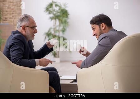 Two businessmen discussing project in the office Stock Photo