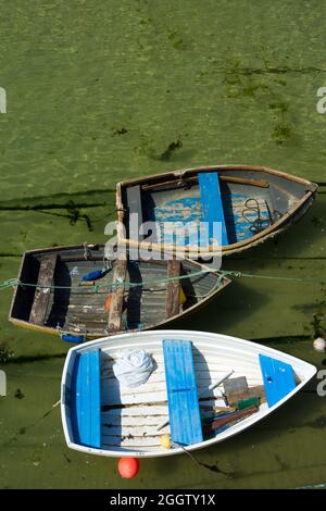 Ariel View Of Three Small Tender Boats In St Ives Harbour. There is negative space above providing space for a caption. Stock Photo