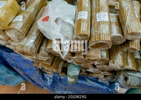 Bundles of wrapped wax candles used in church rituals sold at the stand at Orthodox fair, Moscow, Russia Stock Photo