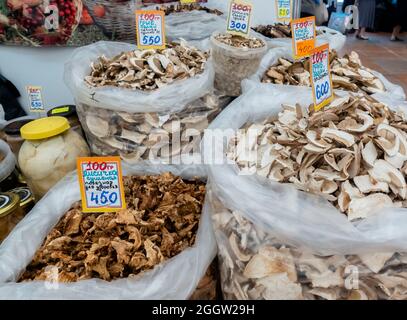 Dried cut mushrooms, Chanterelles and Penny buns, sold in plastic bags at the stand at the fair, Moscow, Russia Stock Photo