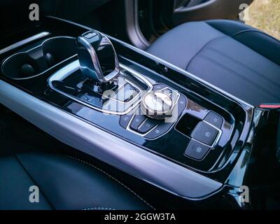 multimedia system control and gearshift in interior of modern premium car, no people. Management of multimedia functions, and options of the car, navi Stock Photo