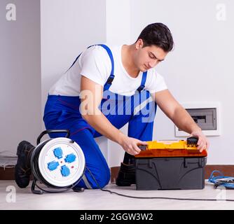 The man doing electrical repairs at home Stock Photo