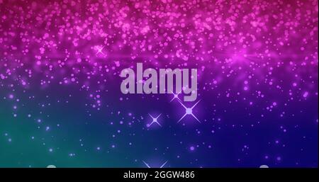 Pink sparkles and glowing spots moving against purple background Stock Photo