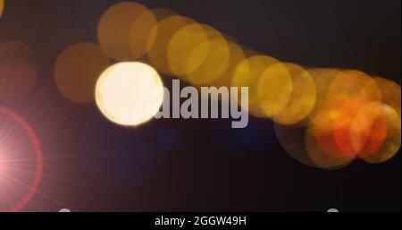 Orange glowing spots of light against black background Stock Photo