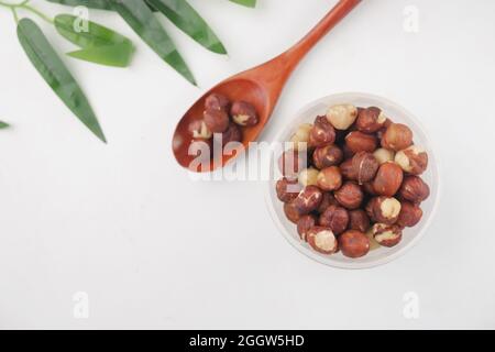 hazelnuts in a container on white background, Stock Photo