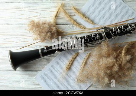Сlarinet, music sheets and reeds on white wooden table Stock Photo