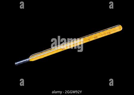 A clinical mercury thermometer on white background calibrated in celsius degrees with the indication in 38 degrees,  100,4 degrees Fahrenheit Stock Photo