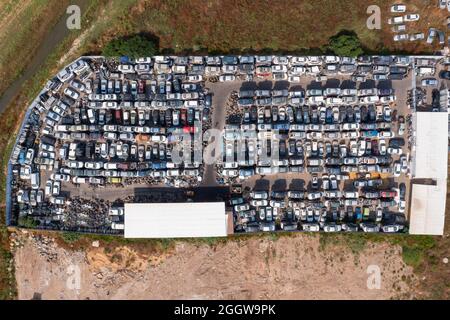 Salvage Car lot with stacks of various cars in a tight storage formation. Stock Photo