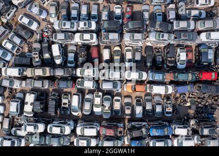 Salvage Car lot with stacks of various cars in a tight storage formation.