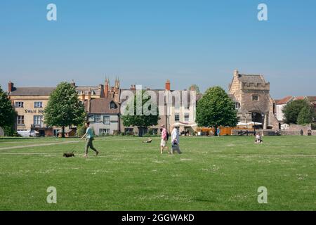 Wells Cathedral Green, view in summer of people walking in Cathedral Green in the centre of the historic city of Wells, Somerset, England, UK Stock Photo