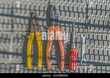 Set of old simple tools pliers, screwdriver and wrench for housework Stock Photo