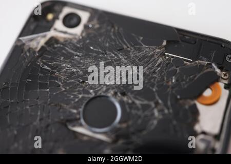 Closeup of black broken mobile phone in workshop Stock Photo