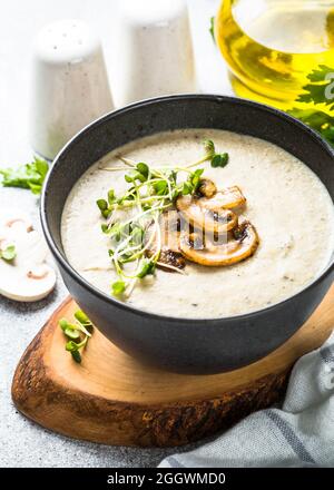 Mushroom Soup in craft bowl on light stone table. Stock Photo