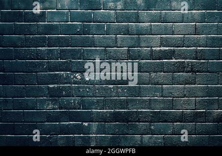 Black old tiled wall lit by sunlight Stock Photo