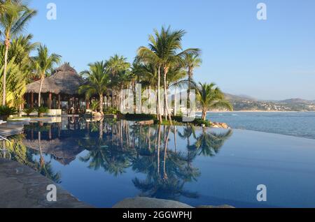 Tropical poolside view of Agua the fine dining restaurant at the luxury resort One&Only Palmilla in San José del Cabo, Baja California Sur Mexico. Stock Photo