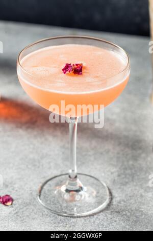 Cold Refreshing Rose Petal Cocktail with Gin and Lemon Stock Photo