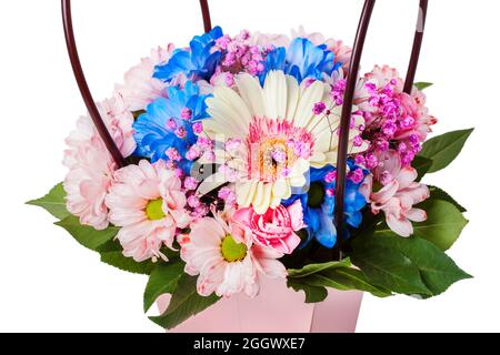 Basket with colorful flowers close up isolated on white Stock Photo