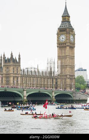 Part of the Thames Diamond Jubilee Pageant passing The Palace of Westminster London, Britain. The Pageant was made up of hundreds of boats that sailed from Battersea Bridge to Tower Bridge to celebrate Queen Elizabeth II's 60 years on the throne. Millions of people lined the banks of the Thames to watch the spectacle.  South Bank, London, UK.  3 Jun 2012 Stock Photo