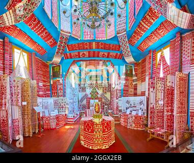 PEREIASLAV, UKRAINE - MAY 22, 2021: Museum of Rushnyk with handmade embroidered ritual towels, decorated with red floral, geometric and folk patterns, Stock Photo