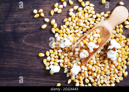 Group of yellow raw corn kernels sweet corn. Grain seeds ingredient golden maize kernel. Wooden table ripe popcorn background. Stock Photo