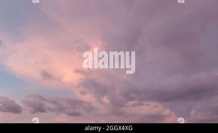 Background of sunset with colorful cloudy sky in twilight time,fluffy cloud before rain Stock Photo