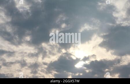 sunset sky soft golden color background of evening with sunlight coming through clouds view before sunset and good atmosphere Stock Photo