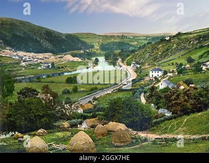 An early 20th century view of the Vale of Avoca in County Wicklow, Ireland. The Avoca area has been associated with its copper mines (visible on the left balk of the on the River Avoca for many years. The valley has also been celebrated by Thomas Moore in the song 'The Meeting of the Waters' derived from the meeting of the Avonmore and Avonbeg rivers, about 3 kilometres from the village of Avoca. Stock Photo