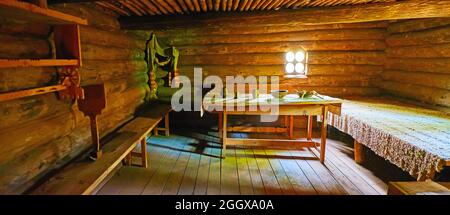 PEREIASLAV, UKRAINE - MAY 22, 2021: Interior of the ancient Slavic timber house with wooden furniture,  Pereiaslav Scansen, on May 22 in Pereiaslav Stock Photo