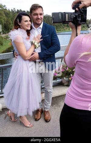 European couple wedding, photographer at work taking pictures on the bridge in Ogre city, Latvia Stock Photo