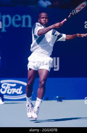 American tennis player Malivai Washington (background right) watches a