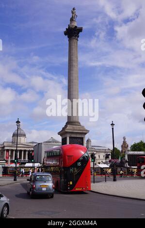 London, UK: a red bus passing under the Nelson's Column in Trafalgar Square Stock Photo