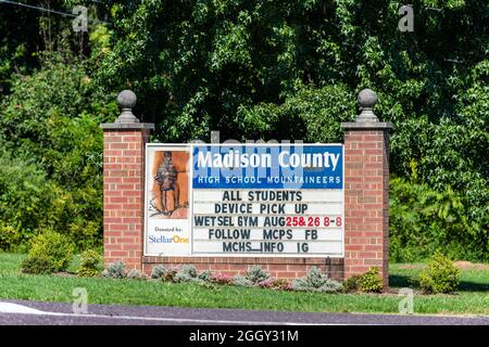 Madison, USA - August 30, 2020: Madison county in Virginia with sign at entrance of high school with text for mountaineers students device pick up at Stock Photo