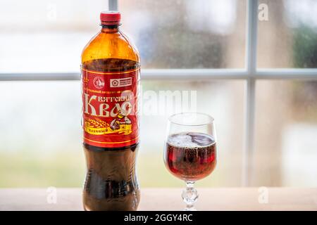 Herndon, USA - December 17, 2020: Bottle of storebought traditional Russian Kvass fermented bread drink with glass illustrative editorial on home tabl Stock Photo