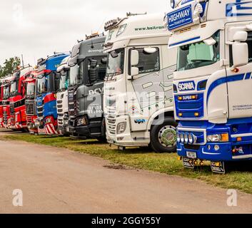 East of England Truck Fest 2021 truck festival held in Peterborough, UK – August 30 2021.Row of commercial HGV lorries parked up on public display. Stock Photo