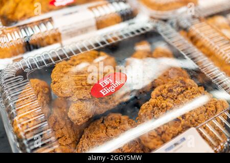 Sterling, USA - March 20, 2021: Closeup of deep fried chicken on retail display in container at Food Lion grocery store supermarket with EBT eligible Stock Photo