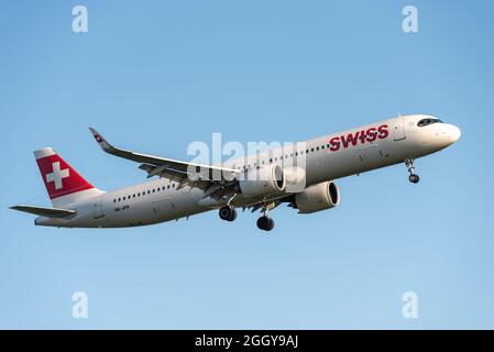 Swiss International Air Lines Airbus A321 airliner jet plane HB-JPB landing at London Heathrow Airport, UK, in blue sky. Airbus A321NEO Stock Photo