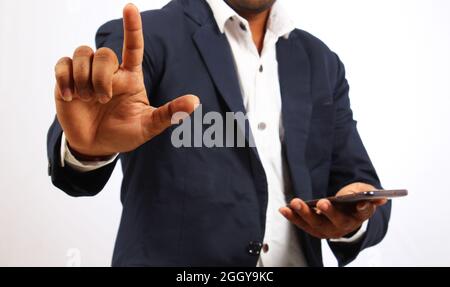Close up of an Engineer using a smart phone with an isolated white background Stock Photo