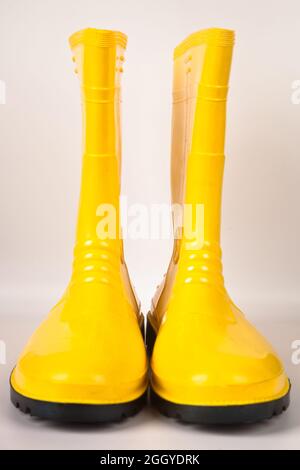 Robust and waterproof yellow rubber boots isolated on white background Stock Photo