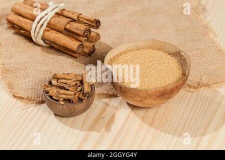cinnamon stick and brown sugar; photo on wooden background. Stock Photo