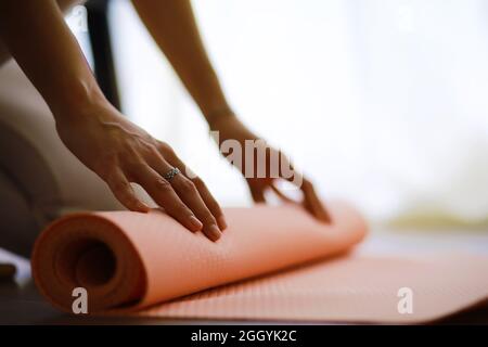 Beautiful athletic girl doing yoga exercises enjoy meditation at home. No stress, healthy habit, anxiety relief concept. Lotus. Stock Photo