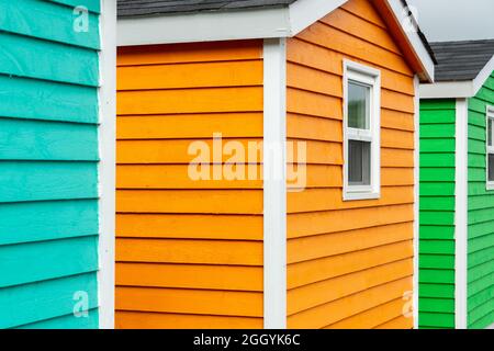 A row of small colorful painted huts or sheds made of wood. The vibrant exterior walls are colorful. Stock Photo