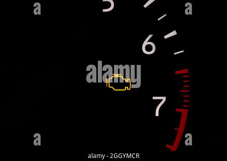 Car check engine warning light on dashboard. Vehicle maintenance, repair and service concept. Stock Photo