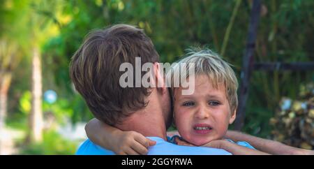 BANNER Close up dad apologize hold hug son in arms. Boy cry look aside. Breakup, father consolation sorry, child psychology, family relationships Stock Photo
