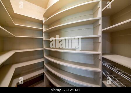 Kitchen pantry interior of a house with wooden shelving unit Stock Photo