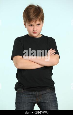 In the portrait, an intelligent and determined teenage boy is serious. Stock Photo