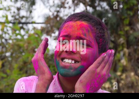 Boy playing with colors, In a happy mood. Concept for Indian festival Holi Stock Photo